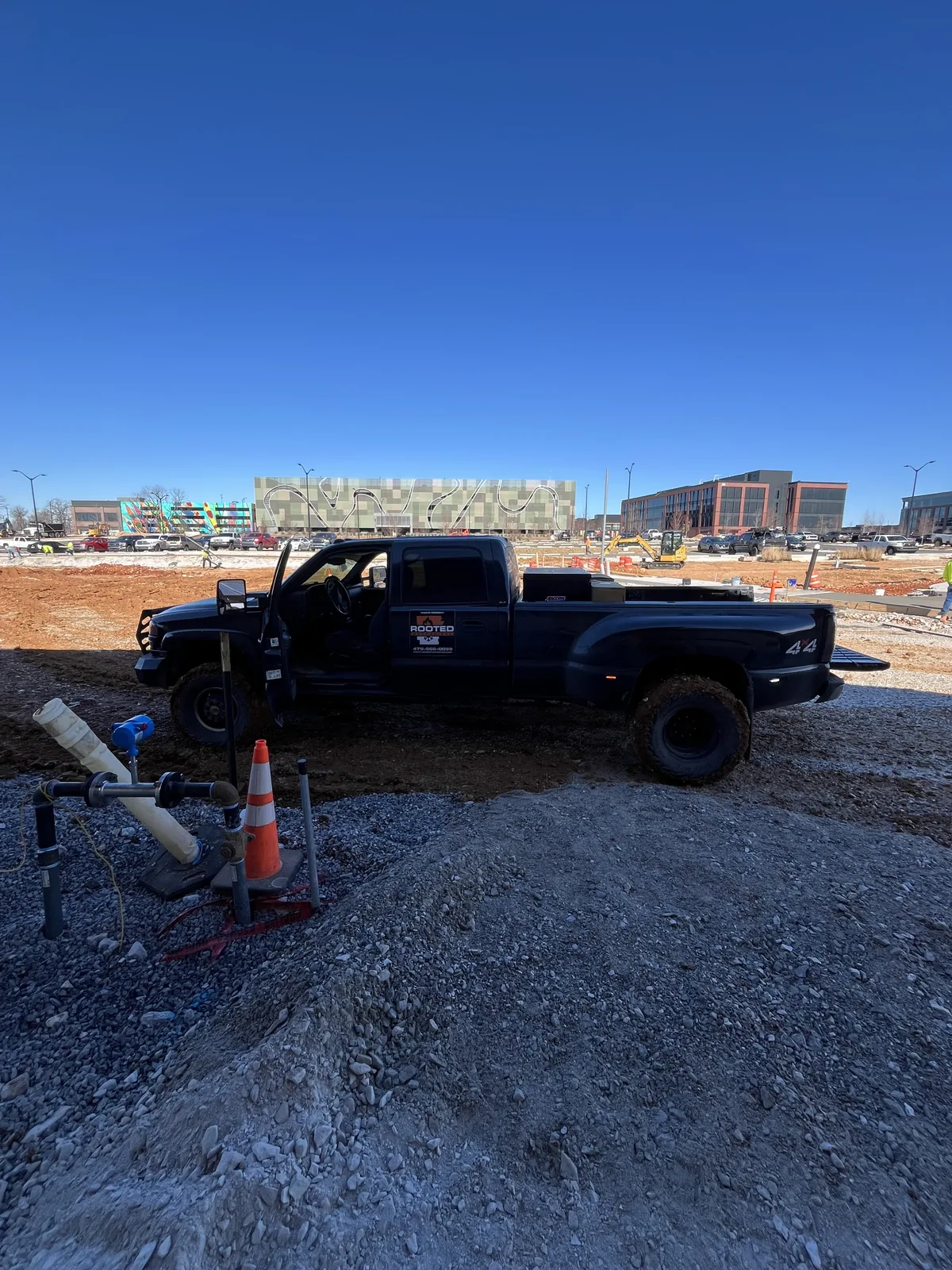 Rooted Mechanical pickup truck with a company door sign parked beside houses under construction