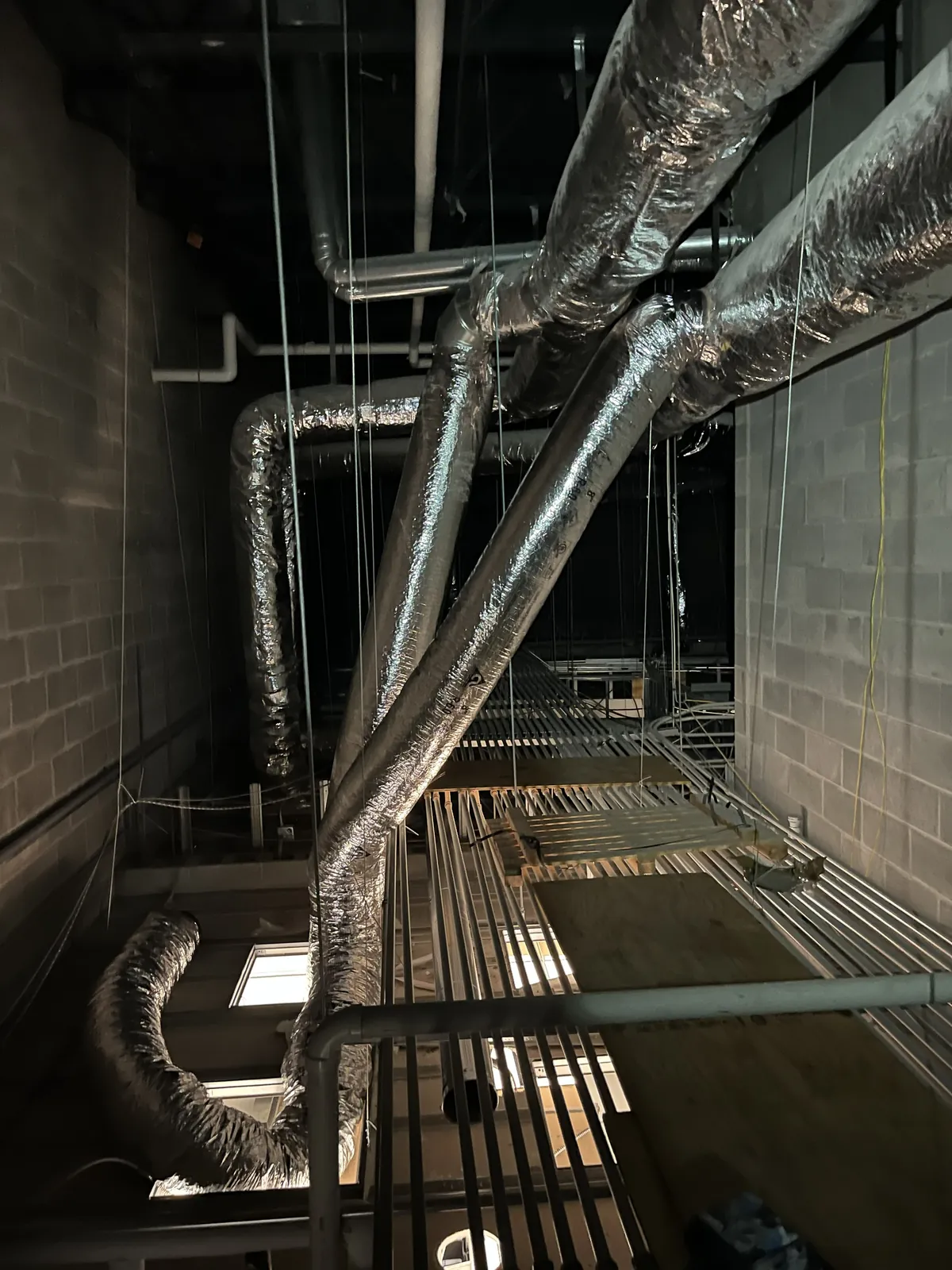 Ductwork going up through an open building during an HVAC install