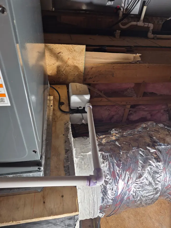 Close view of an outdoor HVAC condenser coil and fan